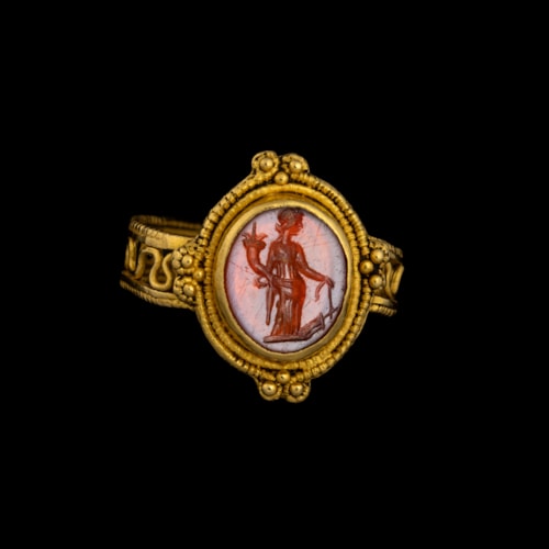 A Late Roman gold ring set with a carnelian intaglio. Tyche.